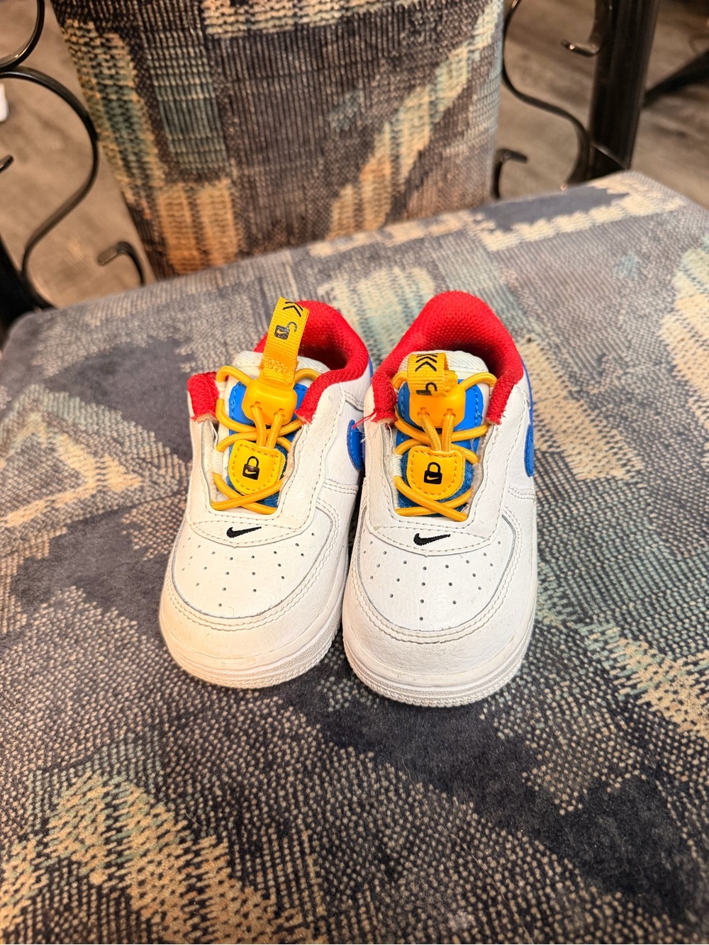 Nike White Kids Sneakers with Red Lining, Yellow Laces & Blue Accents